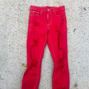 Red distressed skinny jeans